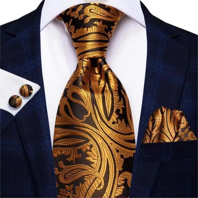 Men's dark blue suit tie set with gold paisley tie, pocket square, cufflinks