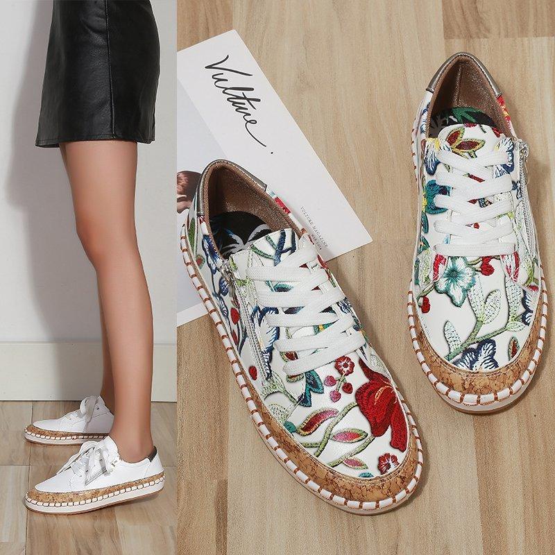 Women’s floral lace-up sneakers with white upper, multicolor print, and brown sole
