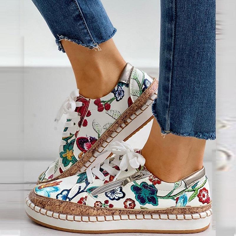 Women’s floral lace-up sneakers with white upper and brown textured sole
