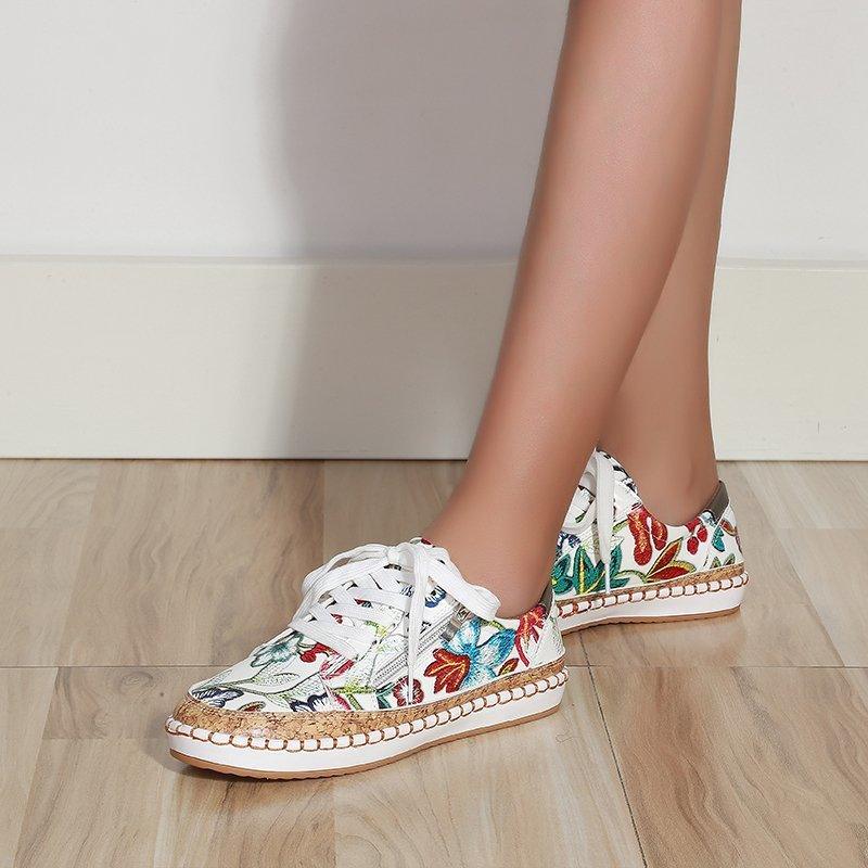 Women’s floral lace-up sneakers with white upper, red and green details