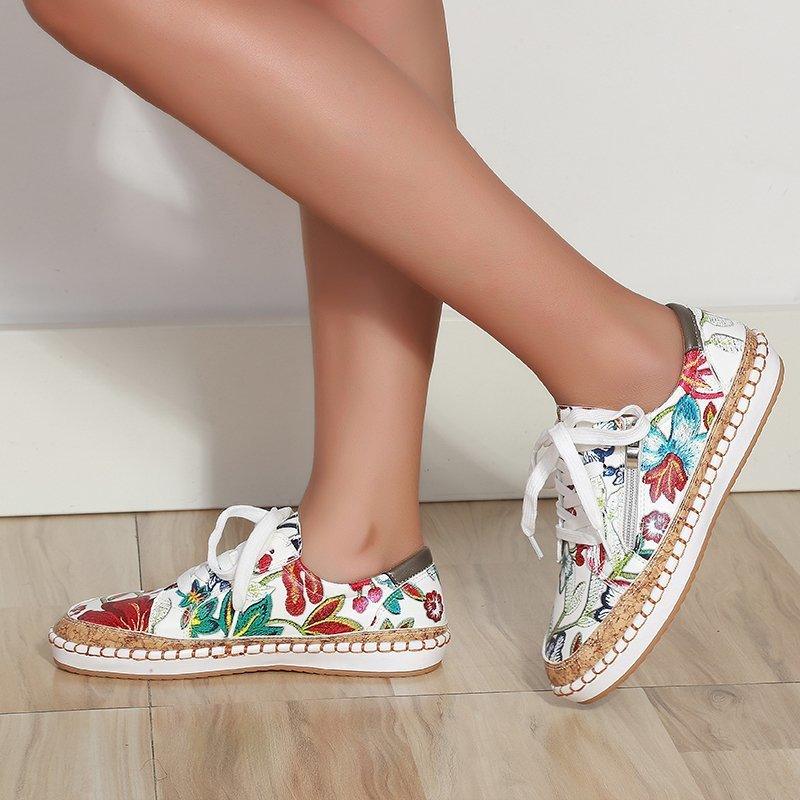 Women’s floral lace-up sneakers with white upper and colorful garden print