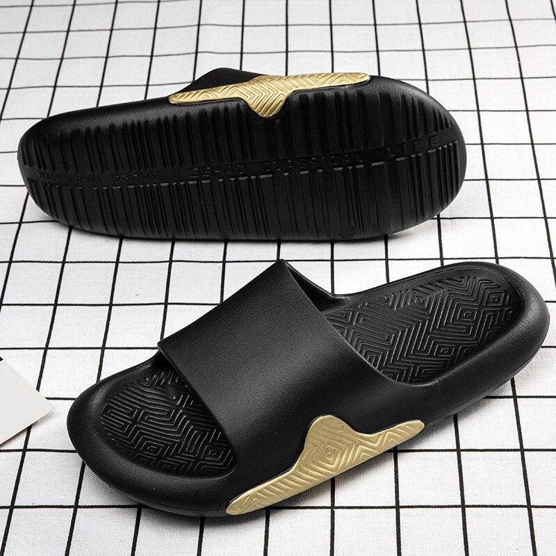 Men’s EVA slide sandals, black with gold textured heel accents and ridged outsole