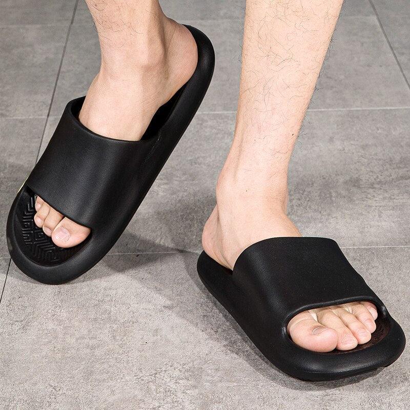 Black EVA slide sandals worn, open-toe design with ridged sole and textured footbed