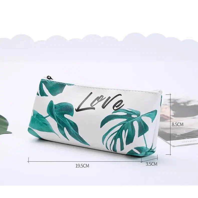 Green tropical leaf print pencil pouch with “Love” graphic; side length shown