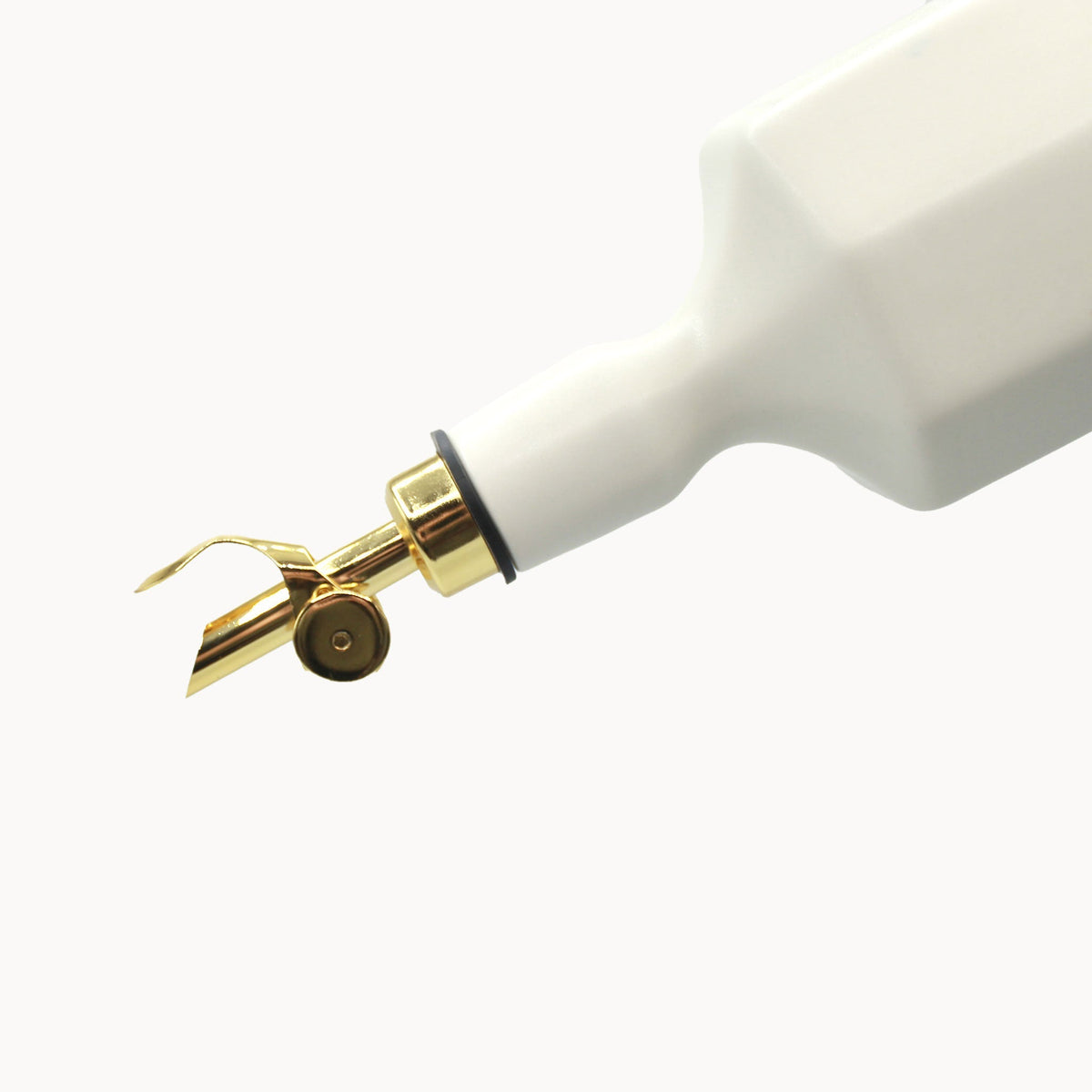 Silk white porcelain olive oil dispenser close-up with gold pour mechanism