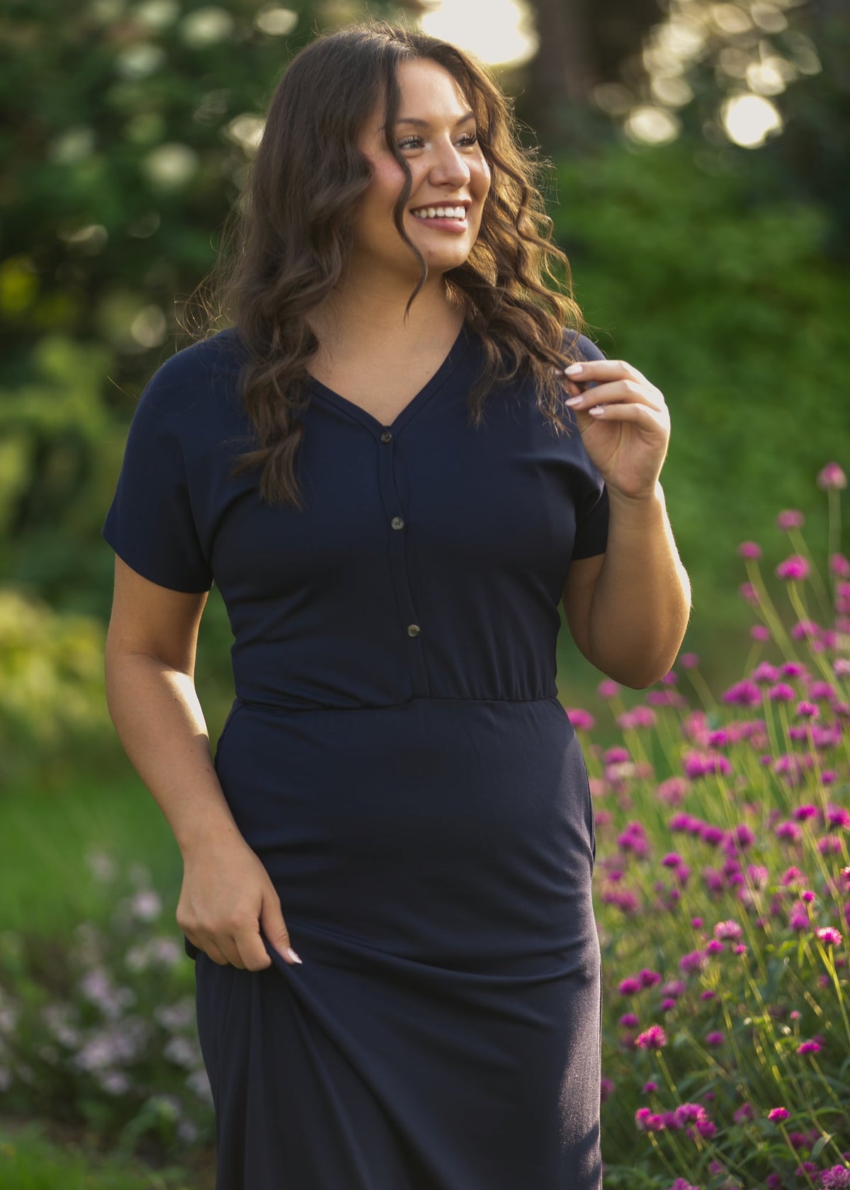 Navy V-neck maxi dress with short sleeves, button front, and cinched waist detail.