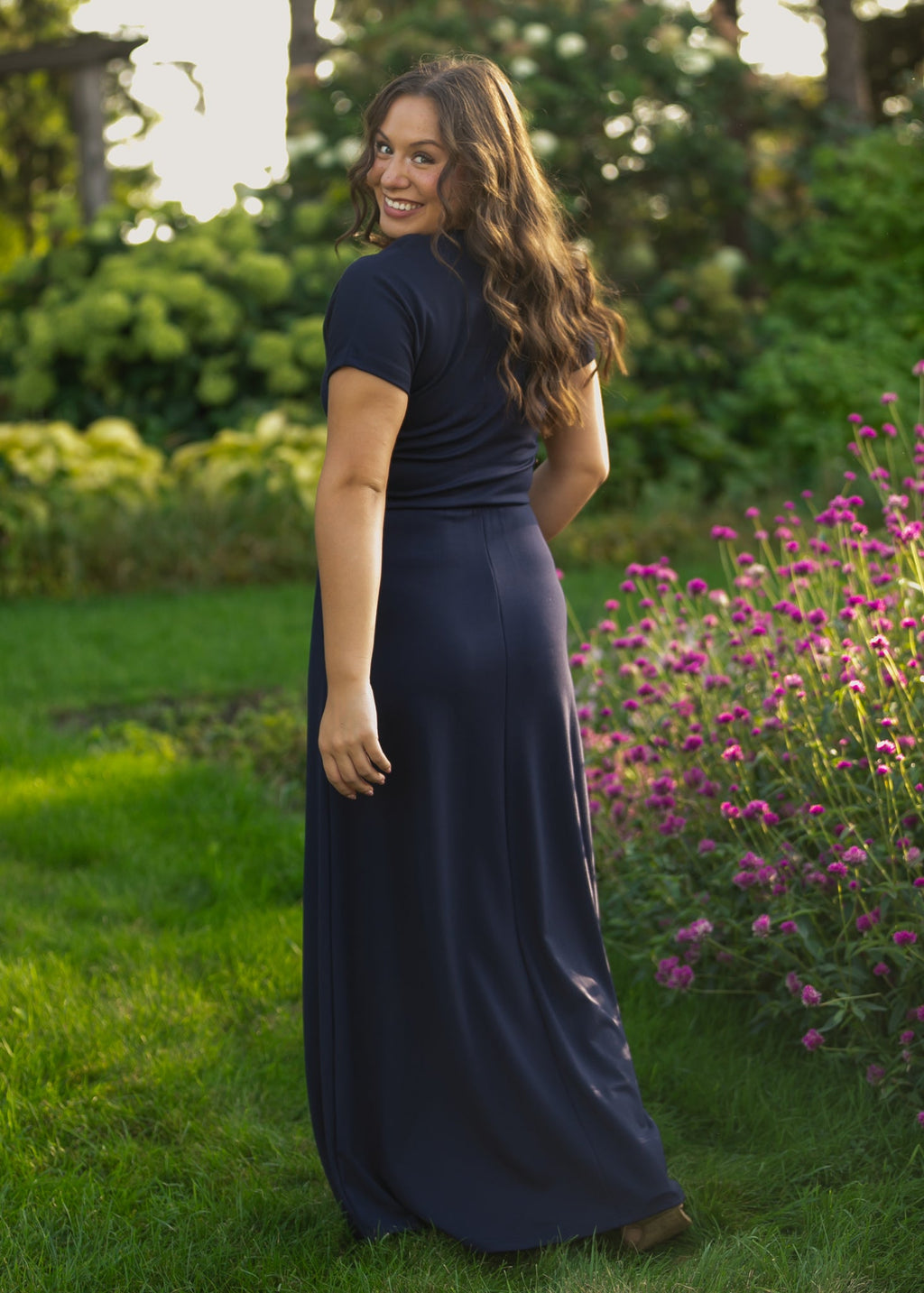 Navy cinched-waist maxi dress, V-neck with buttons and short sleeves, side view.