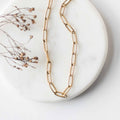 Gold-tone oval-link chain necklace with small clasp and charm detail