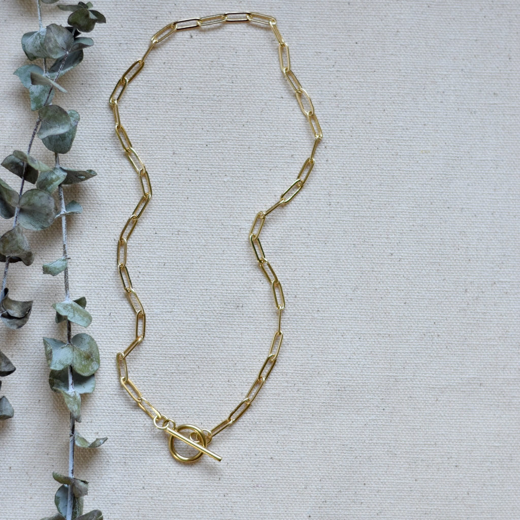 Gold-tone oval-link necklace with clasp detail at the center