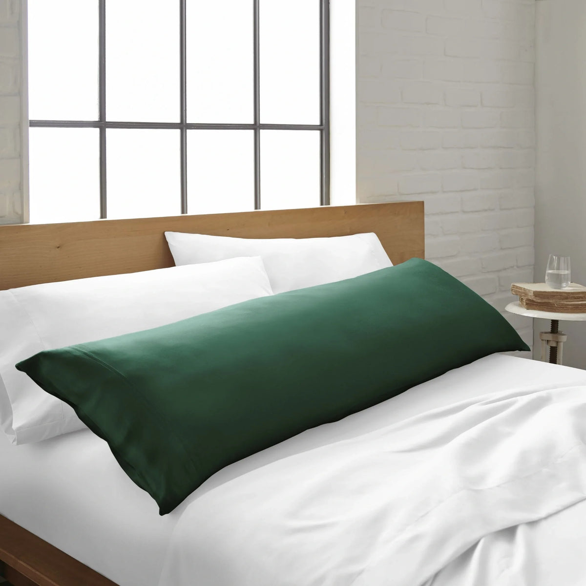 Emerald green body pillowcase with smooth fabric on bed