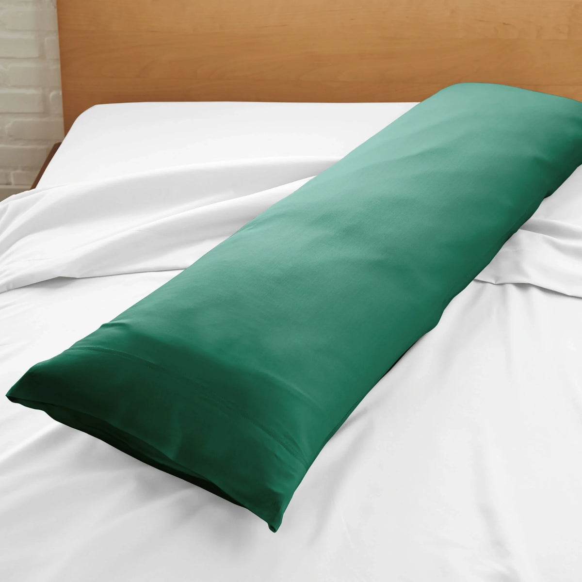 Deep green body pillowcase close-up with smooth fabric on bed