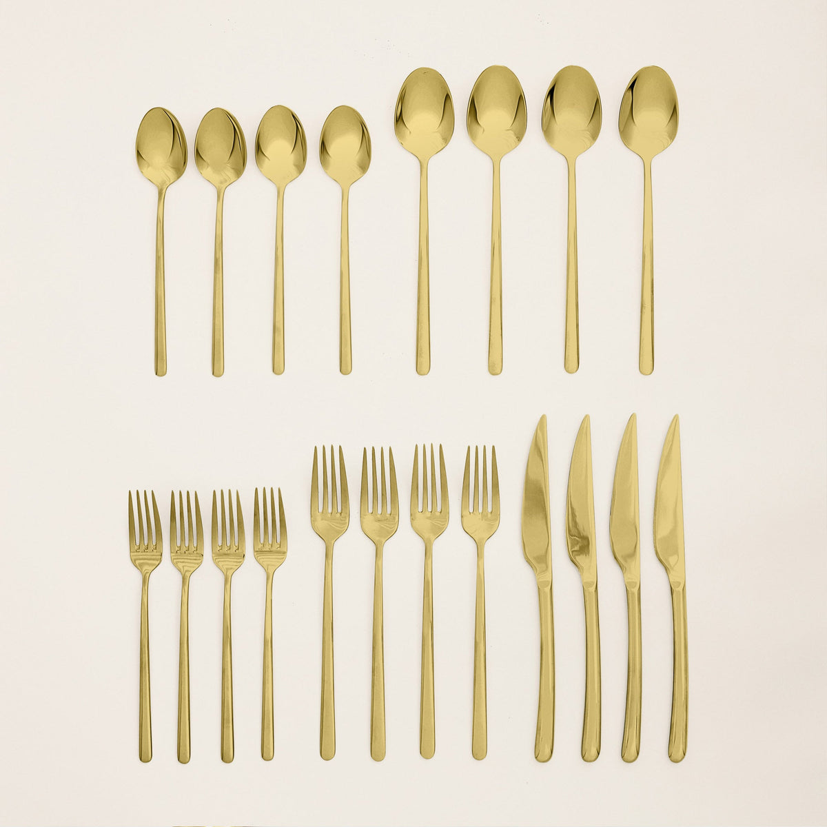 Gold 20-piece flatware set, assorted spoons, forks, and knives arranged