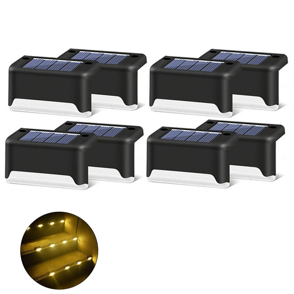 Black solar step light set with warm LED glow and solar panels