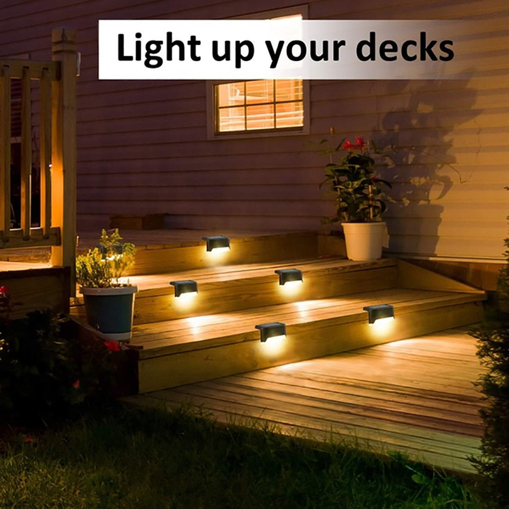 Black solar step lights lighting a wooden deck walkway