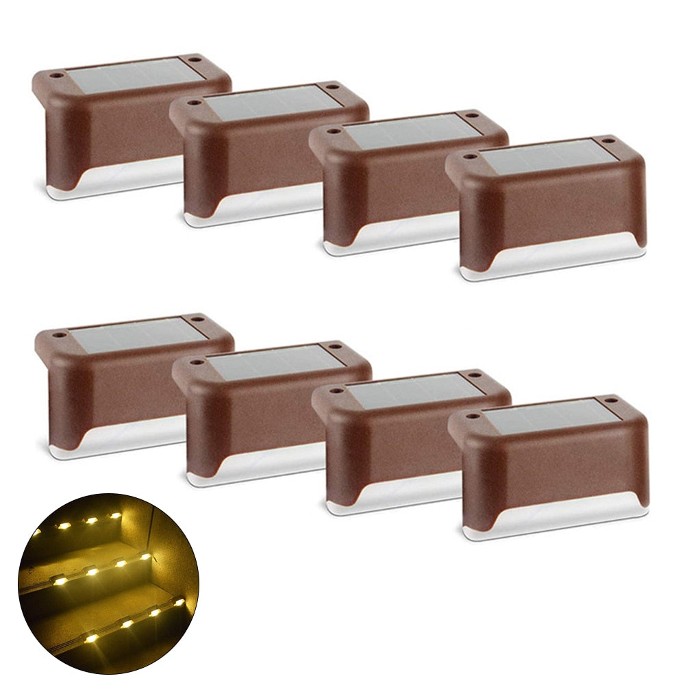 Brown solar step lights set with warm LED glow, multiple mounted units