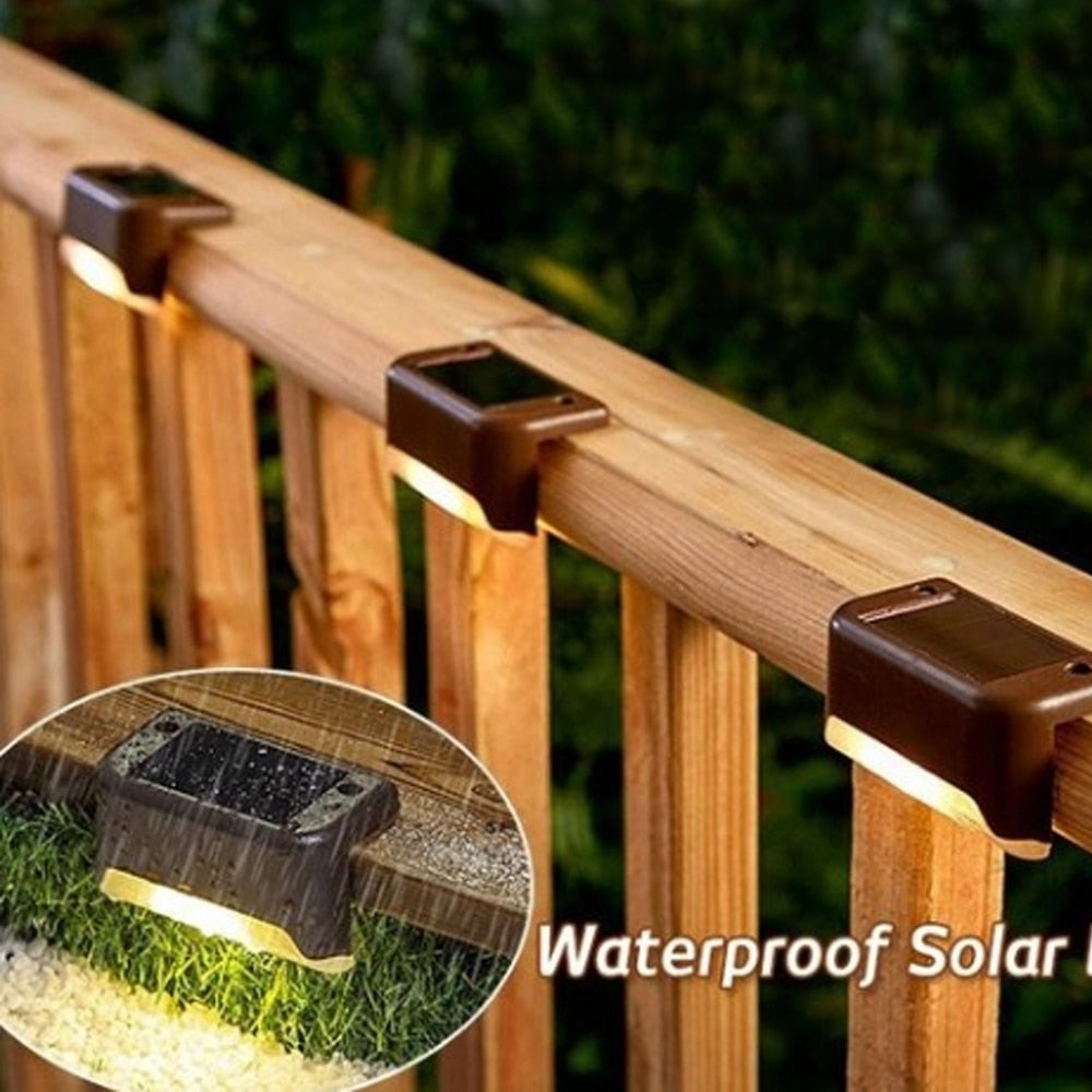 Brown outdoor solar step light with warm LED strip, mounted on wooden railing