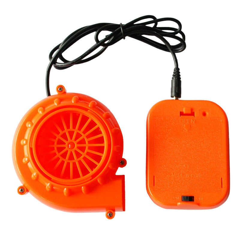 Orange inflatable costume blower fan with control box and black power cord