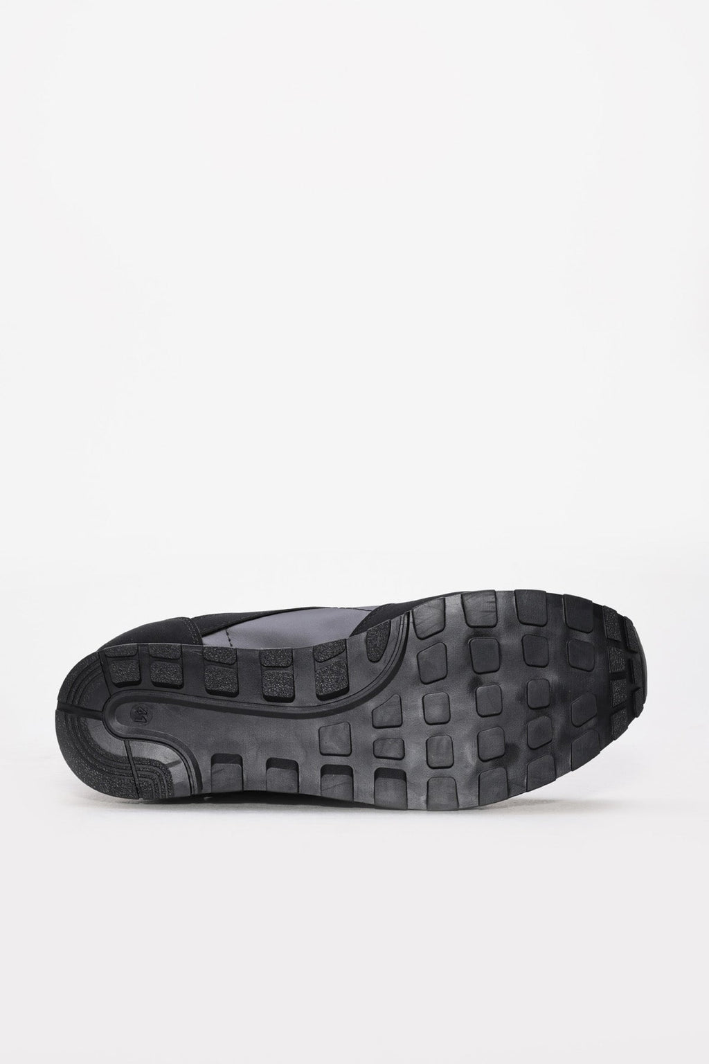 Black sneaker outsole with deep tread pattern