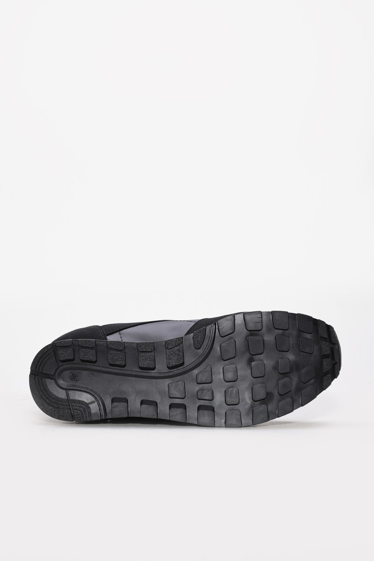 Black sneaker outsole with deep tread pattern