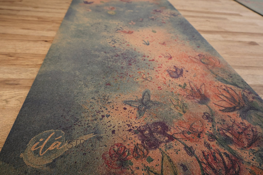 Cork yoga mat with close-up floral artwork and signature near the edge