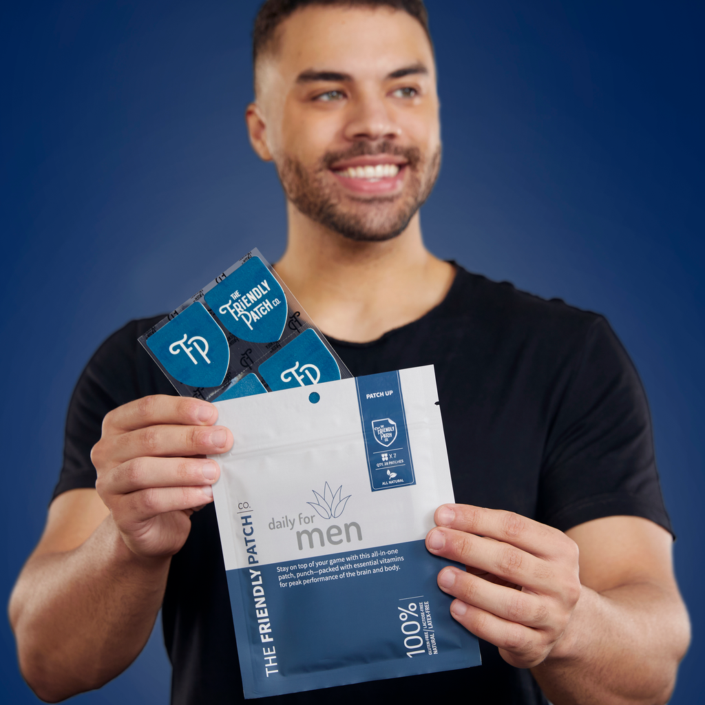 Smiling man holding men’s vitamin patch pouch and individual patch packets