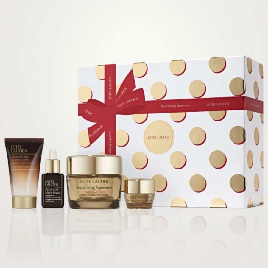 Holiday skincare set in polka-dot gift box with ribbon, plus jar and serum bottles