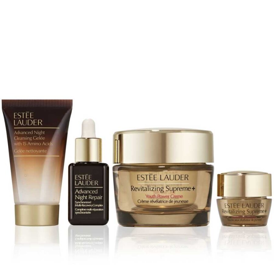 Skincare set with gold jar, dropper serum bottle, small jar, and cream tube