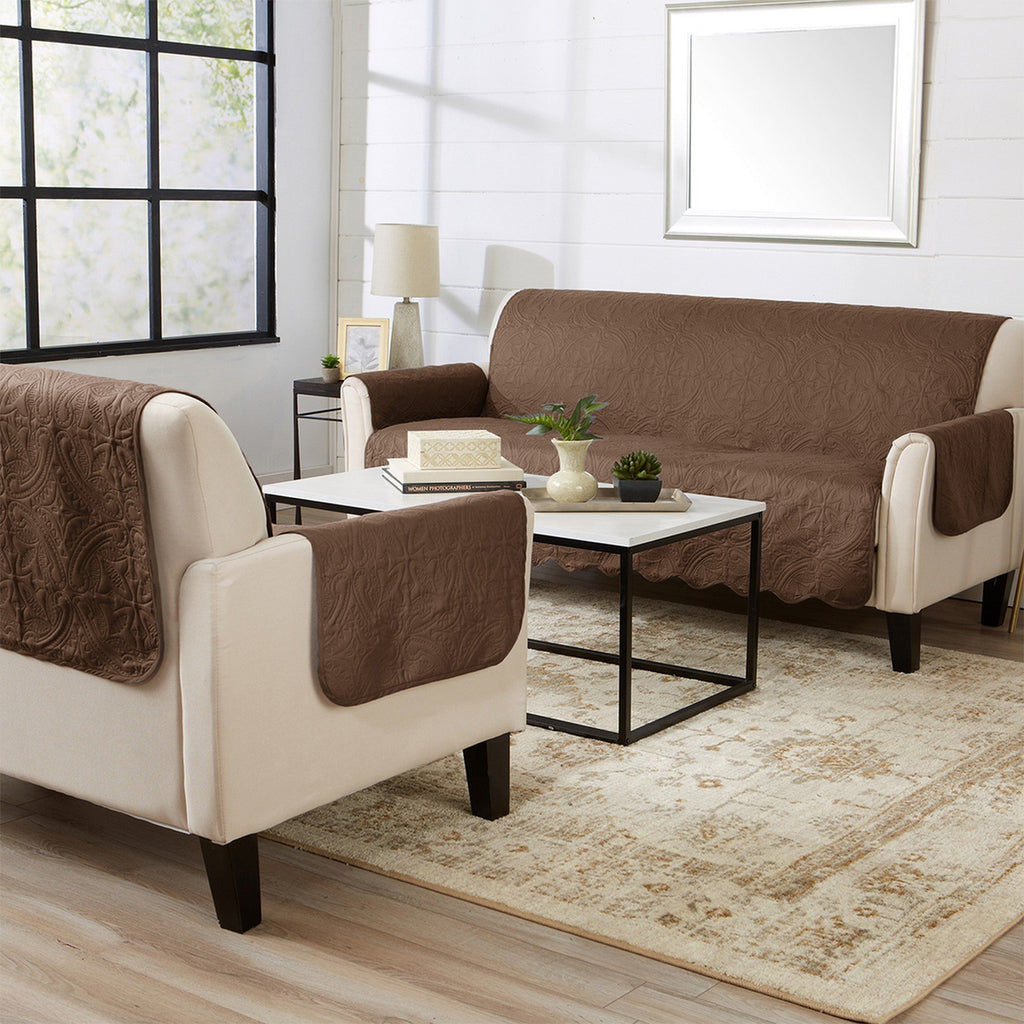 Brown sofa and chair protectors with cream trim and medallion quilt pattern in living room