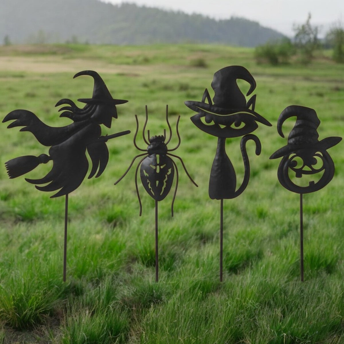 Four black metal yard stakes with Halloween icon silhouettes
