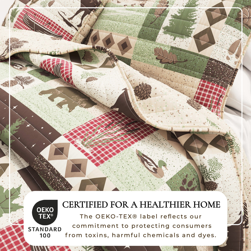 Close-up of lodge patchwork quilt fabric with plaid squares, diamonds, and trees