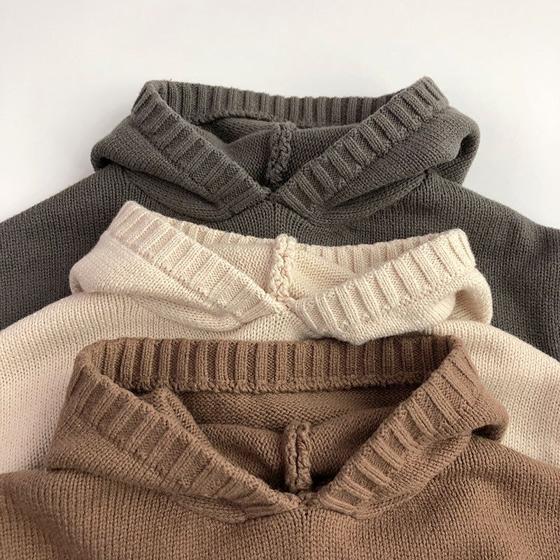 Children's hoodies stacked close-up with ribbed collars in dark gray, cream, beige, and brown