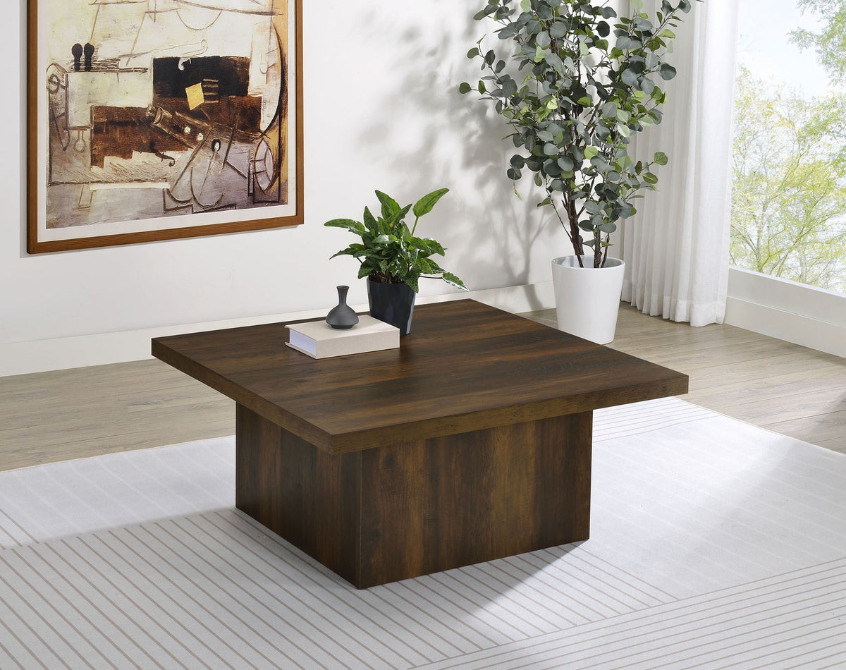 Square dark pine coffee table with flat top, used with plants and decor in room setting