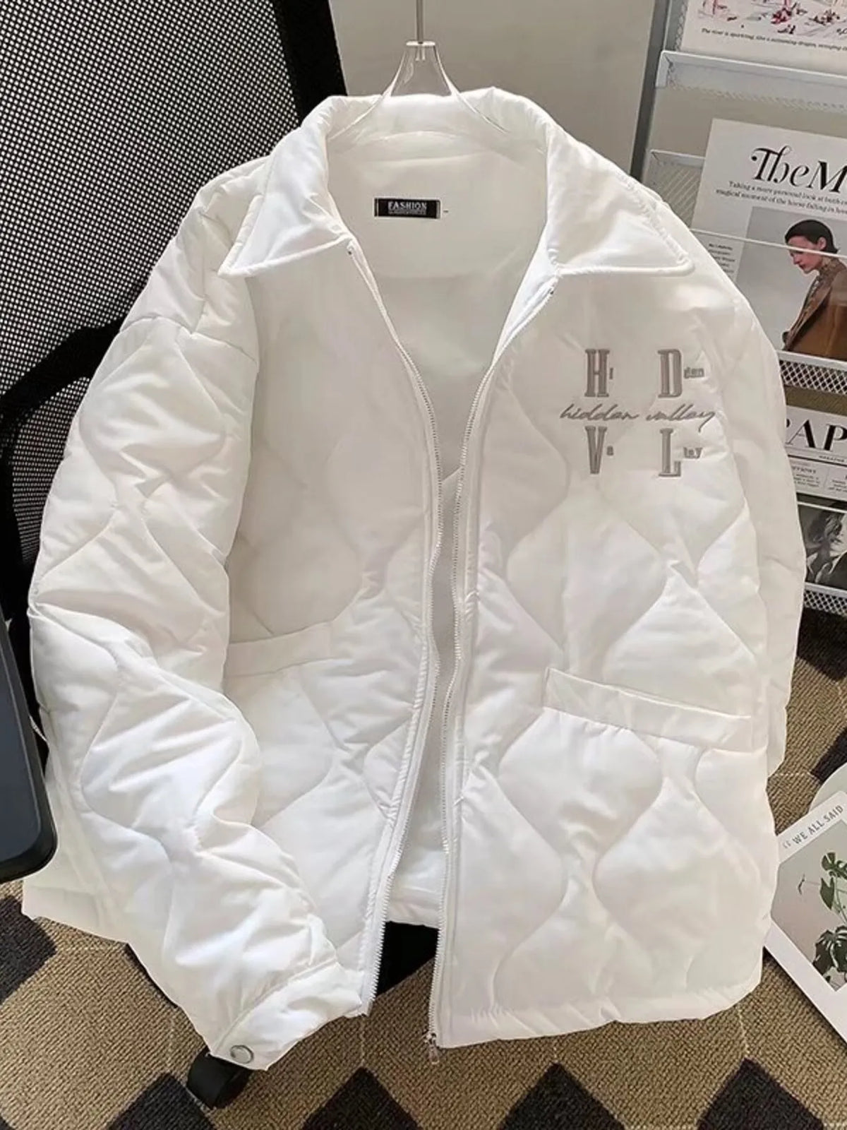 Men's quilted white zip-up jacket front view with logo embroidery on chest