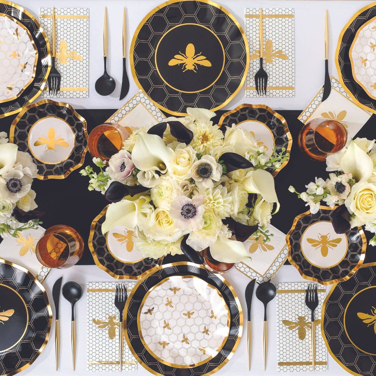 Set of wavy paper salad plates with black hex outlines, gold honeycomb, and bee icons