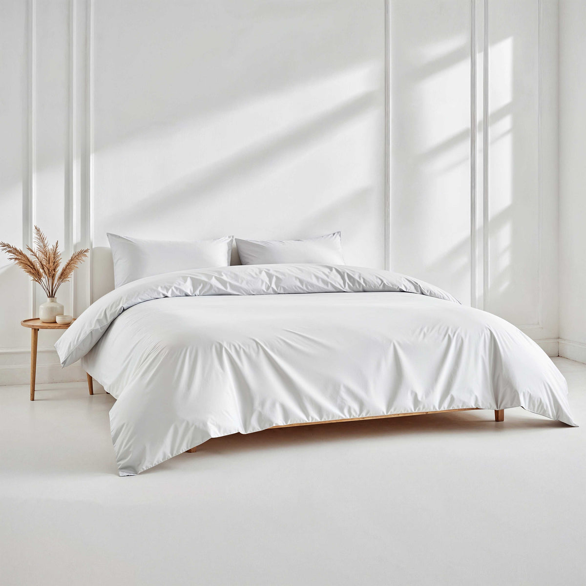 White sateen duvet cover on bed with matching pillow shams and button closure not shown