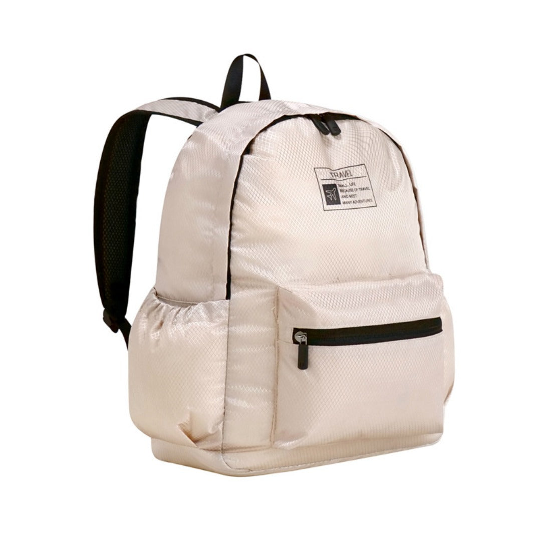 Beige foldable backpack with front zip pocket and adjustable shoulder straps.