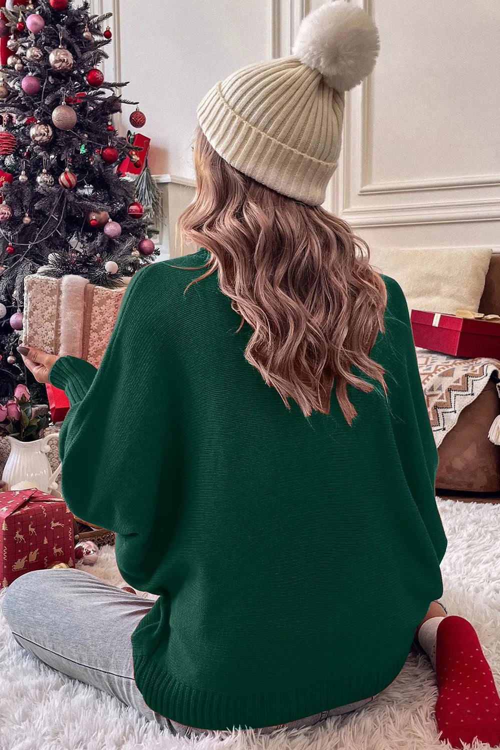 Dark green turtleneck sweater with long sleeves, back view