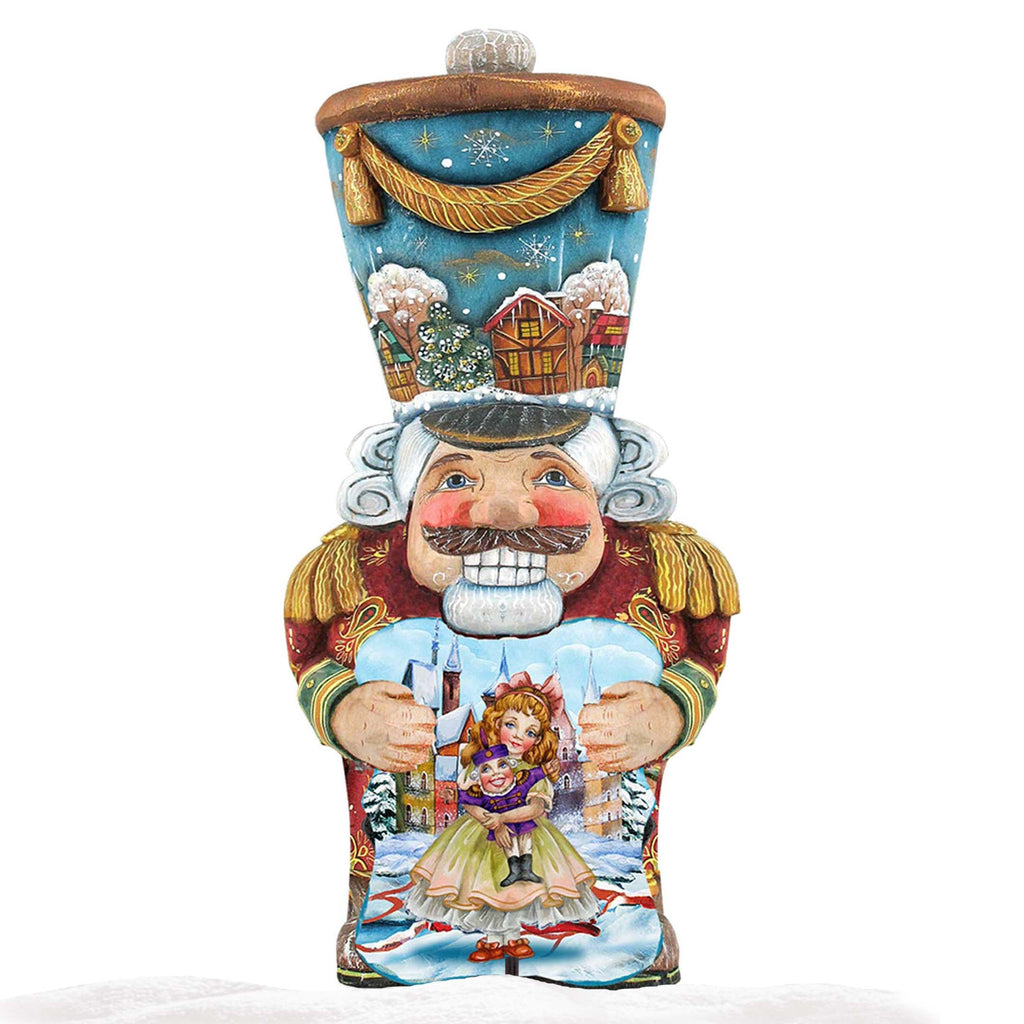 Single painted nutcracker holiday decoration with blue top, holding doll in blue shirt