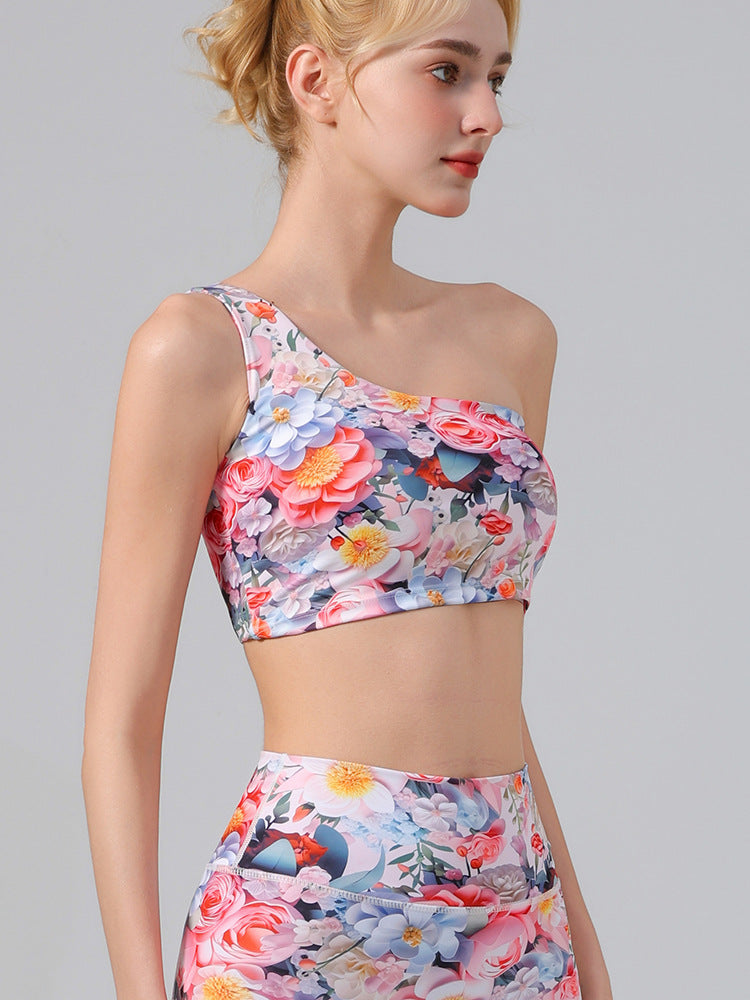 Multicolor floral one-shoulder sports bra and matching cropped yoga shorts, profile view