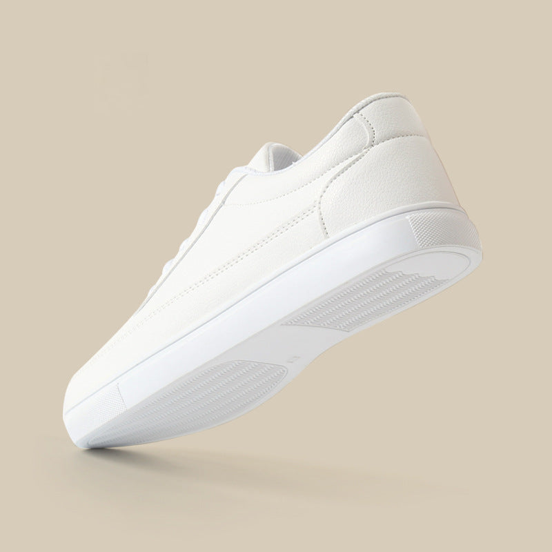 White low-top sneakers side angle showing stitch lines and rubber sole
