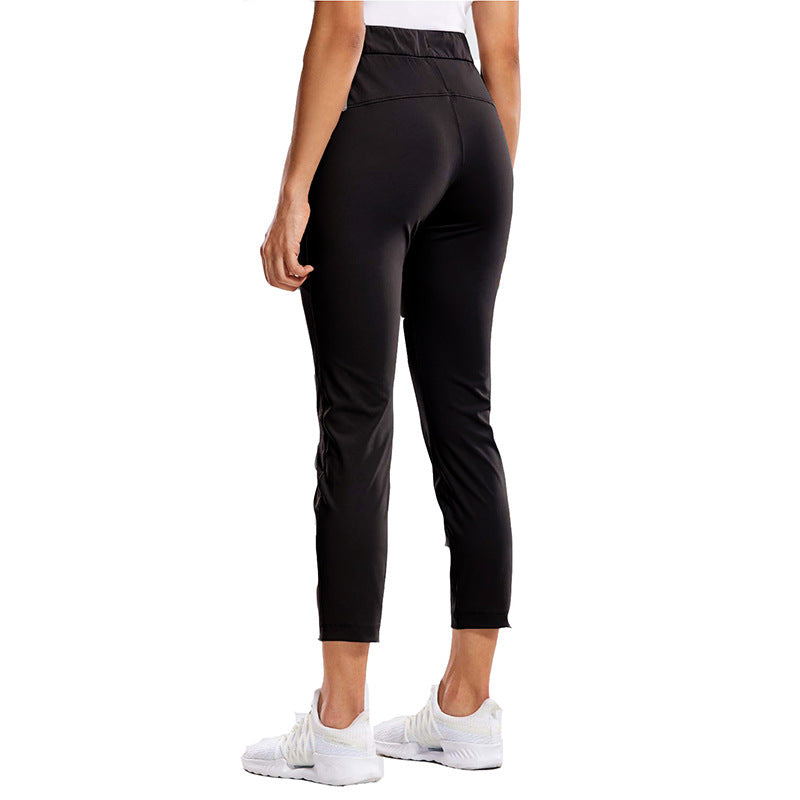 Women's black slim-fit drawstring ankle pants, side view