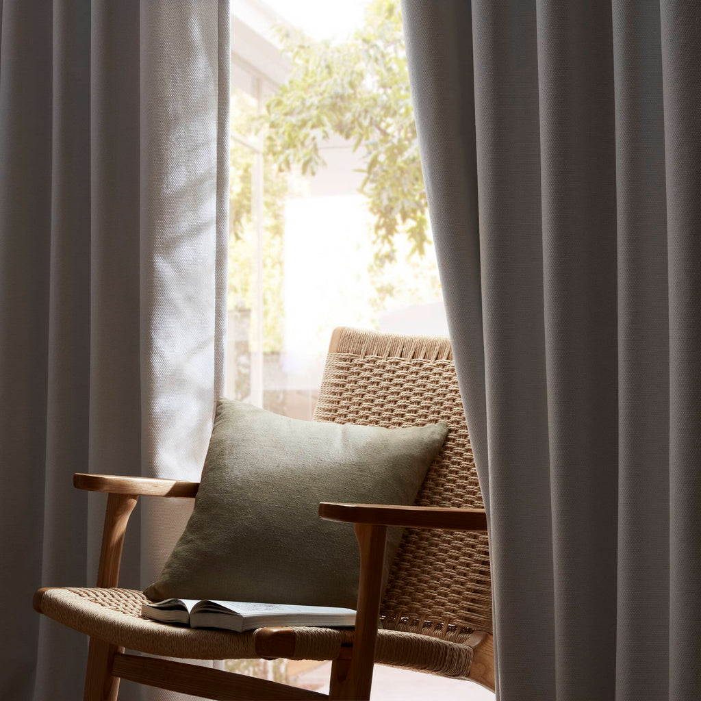 Blackout curtain panel with smooth satin finish and flowing vertical folds