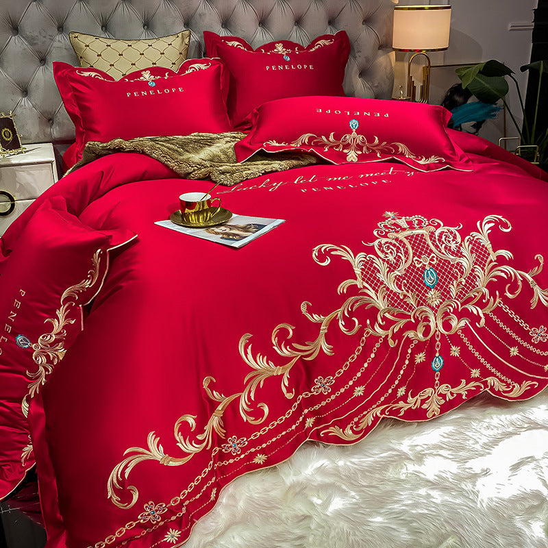 Bright red quilted bed sheet set with gold baroque embroidery and matching pillowcases