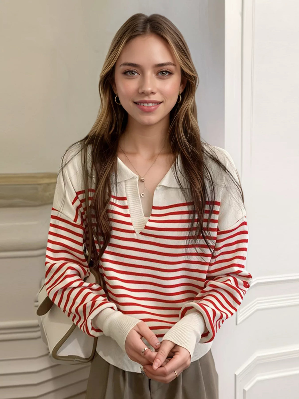 Red-and-white striped knit long-sleeve top with buttoned V-neck placket, soft drape