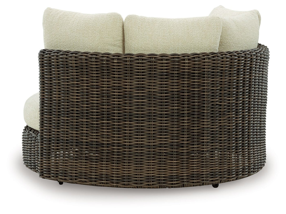Dark brown woven swivel lounge chair with beige seat and back cushions