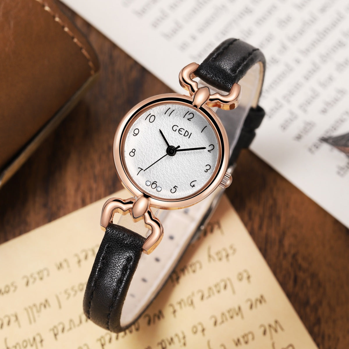 Petite ladies quartz watch with black leather strap and rose-gold round case