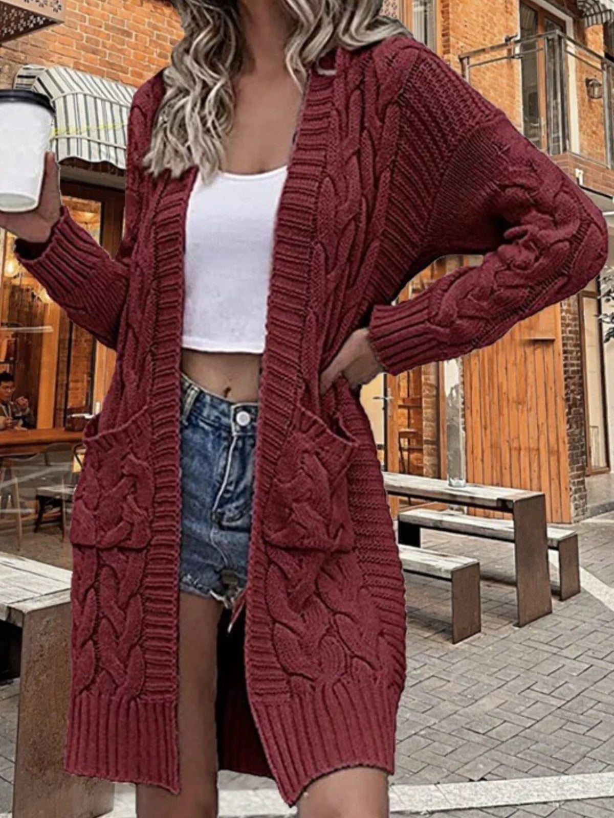 Burgundy chunky knit open-front cardigan with long sleeves and cable-knit texture