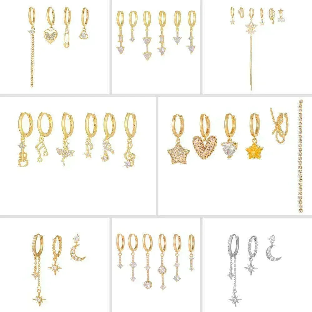 Gold-tone stacking earrings with small heart and star charms, arranged in a grid display.