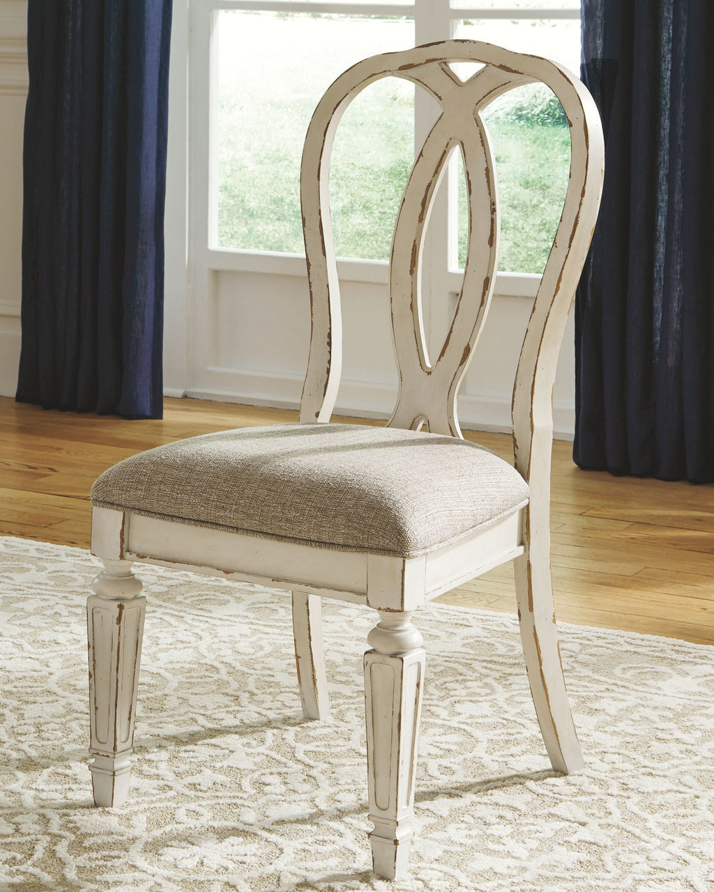 White ladderback dining chair with upholstered beige seat and turned legs