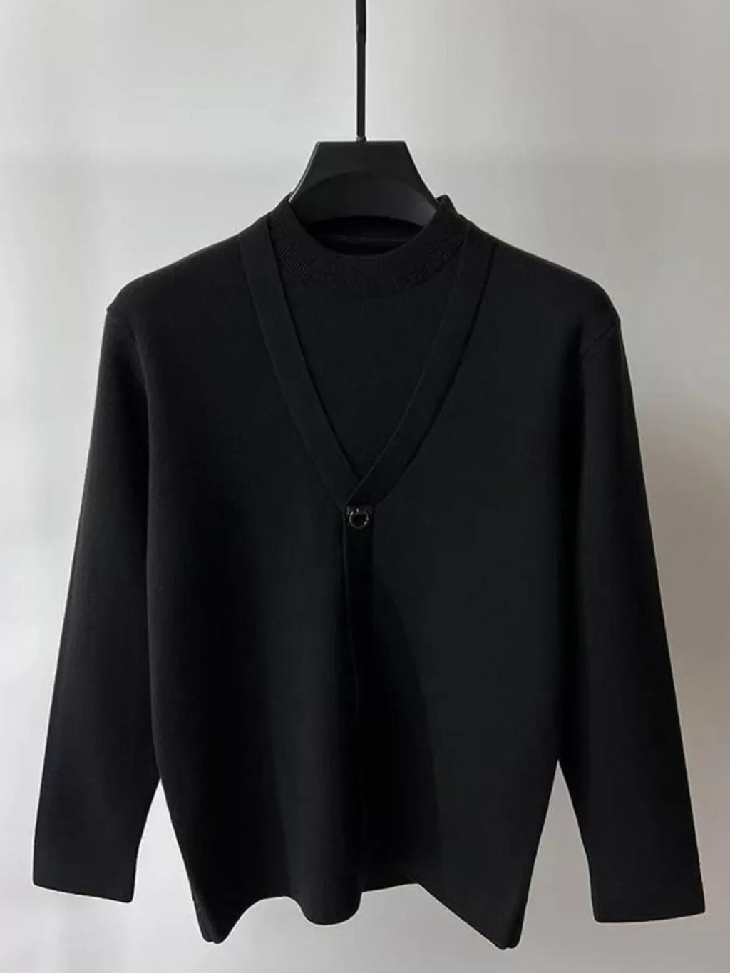 Black knit long-sleeve sweater with V-neck wrap and ring-loop chest closure